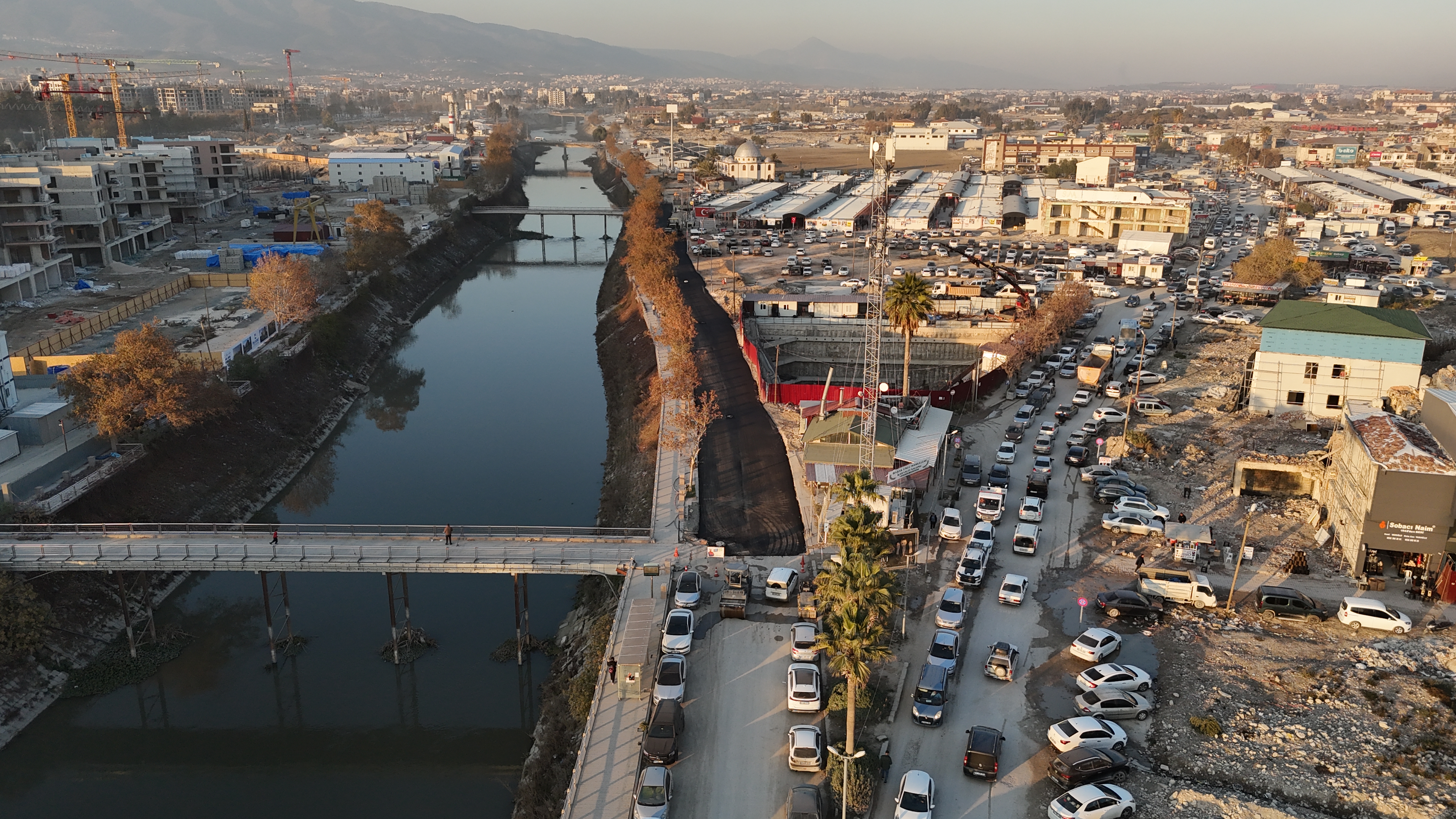 Hatay Büyükşehir Belediyesi, Antakya İzzet Güçlü Caddesi'nde sıcak asfalt serimi yaparak trafik güvenliğini artırıyor ve ticari canlılığı destekliyor. Çalışmalar gece-gündüz aralıksız sürüyor.